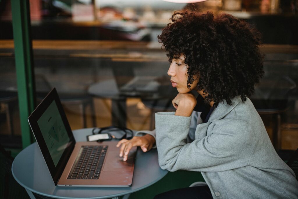 Young person job hunting on a laptop after being made redundant