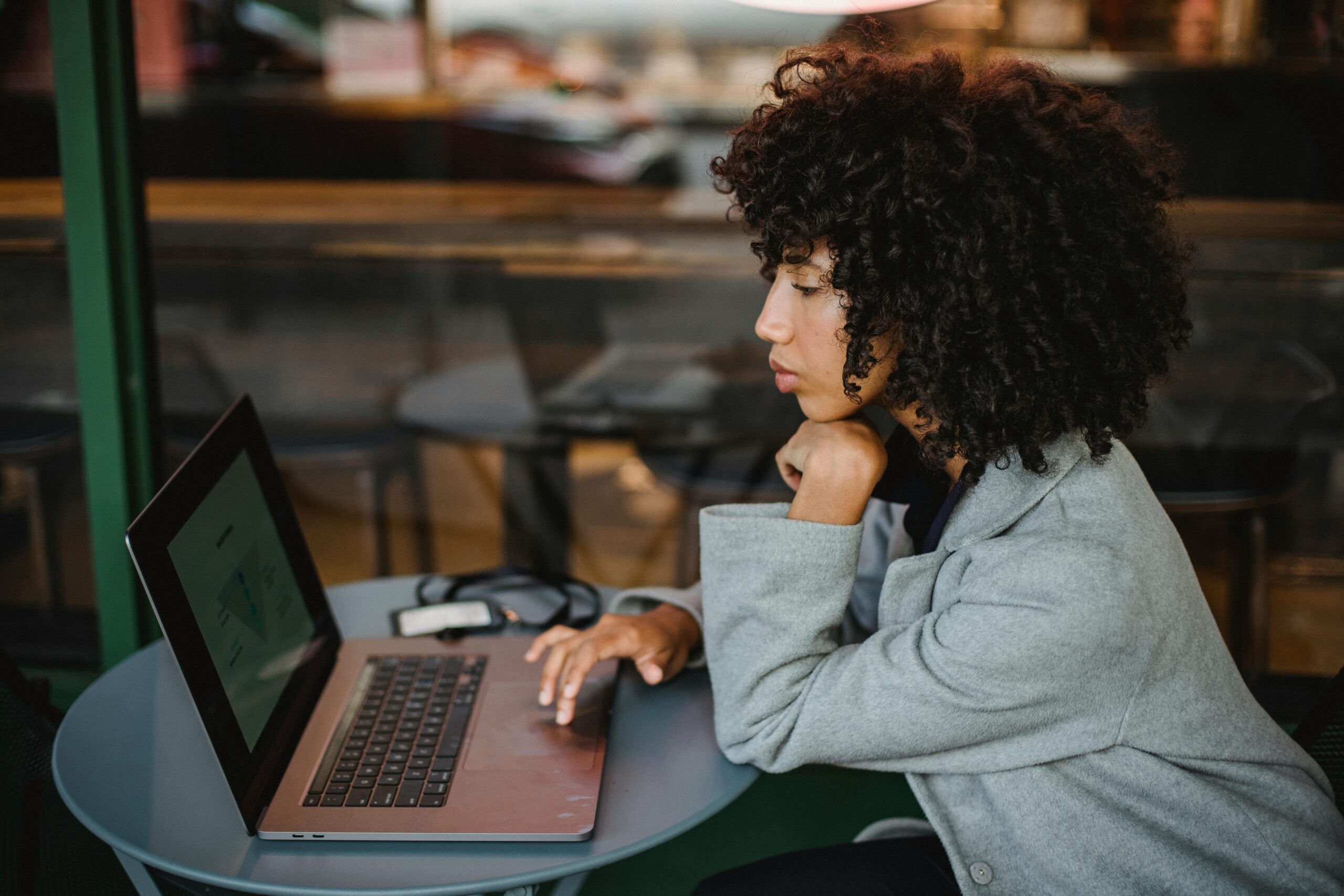 Young person job hunting on a laptop after being made redundant