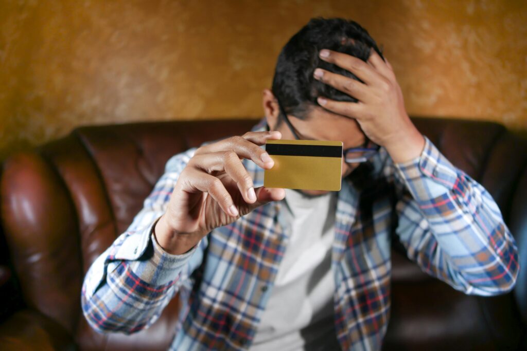 A young person reviewing credit card statements and bills