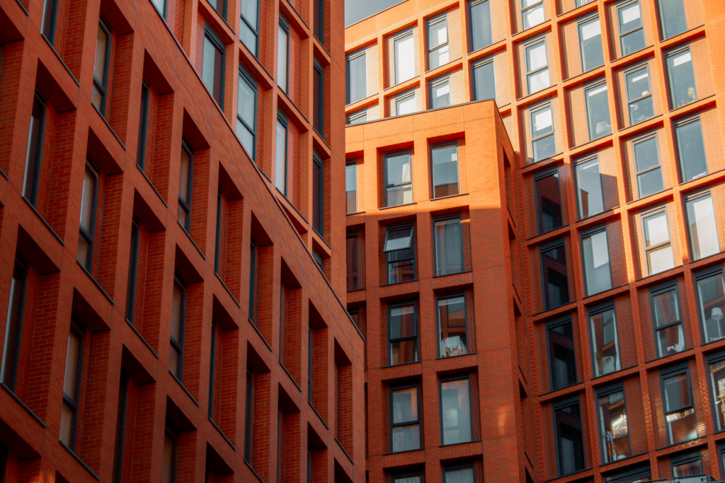 Modern red brick apartment blocks with large windows in Manchester