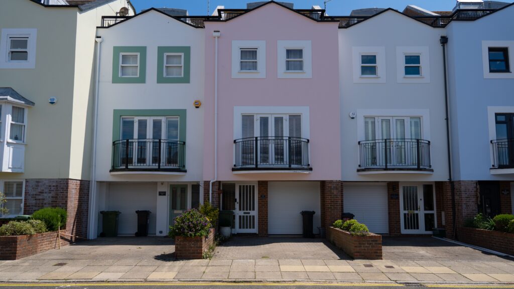 Row of pastel coloured terraced town houses with balconies in Portsmouth