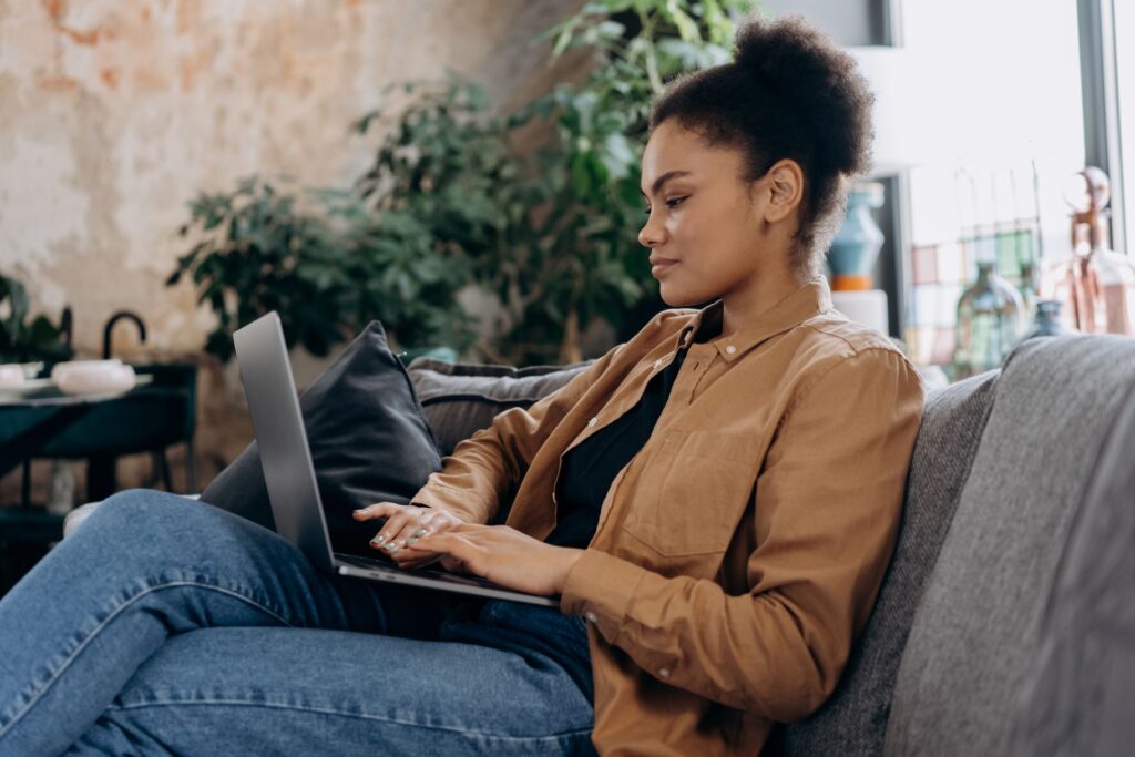 Young woman managing her accounts on a laptop at home