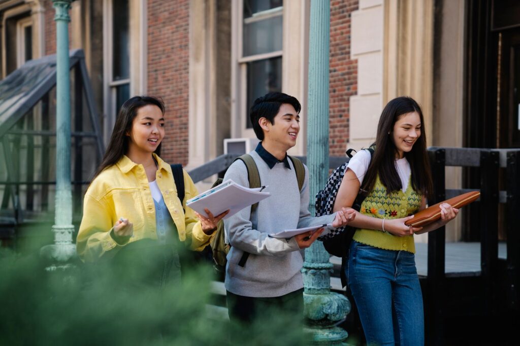Three university students walking together on campus