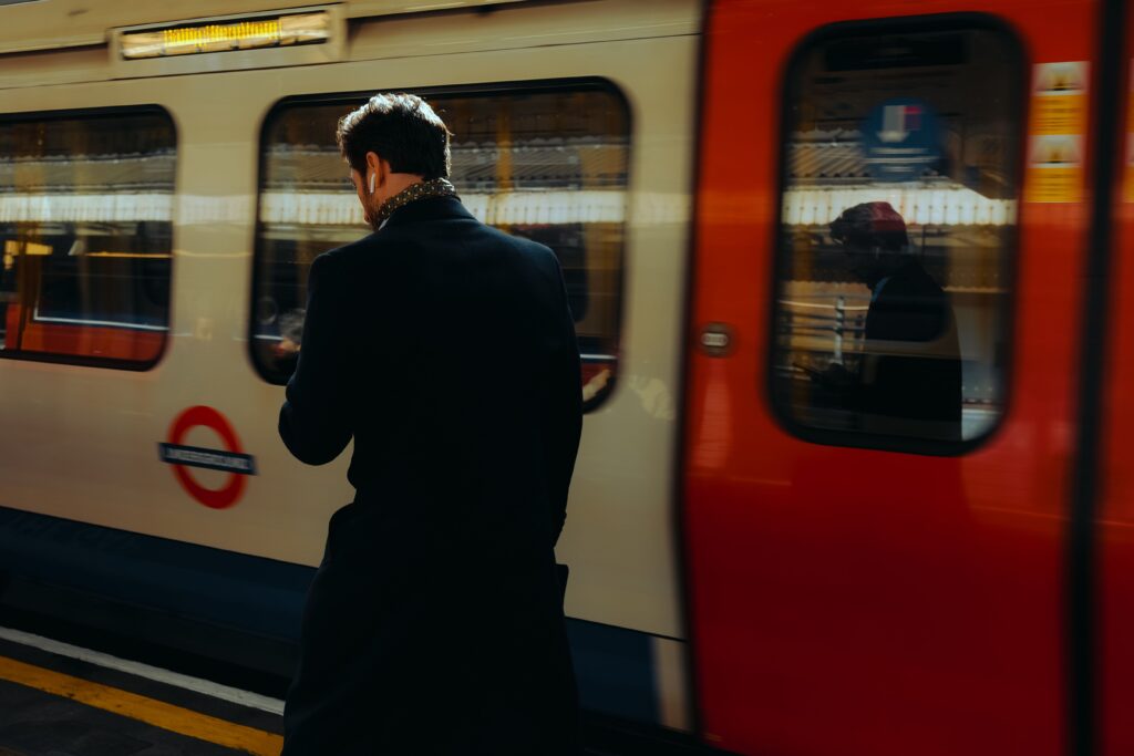 Commuter boarding a London Underground train with the roundel visible
