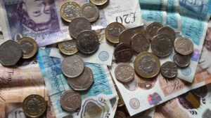 Close-up of British coins and banknotes, showing different denominations for financial concepts.