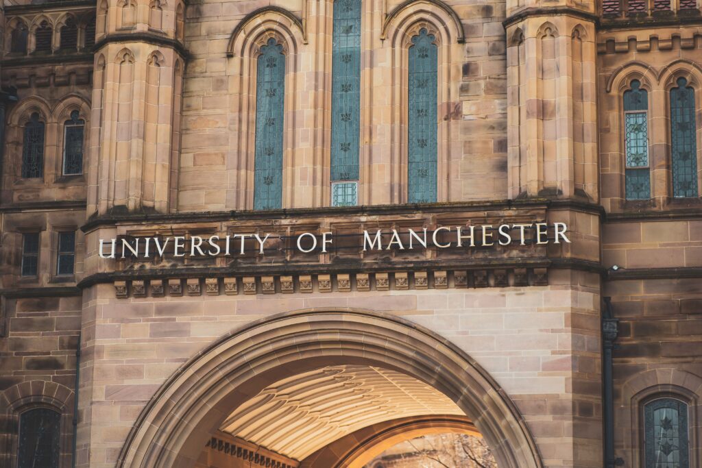 Stone entrance arch of the University of Manchester with carved lettering