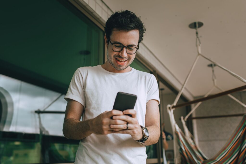 New graduate checking a first payslip student loan repayment on a phone
