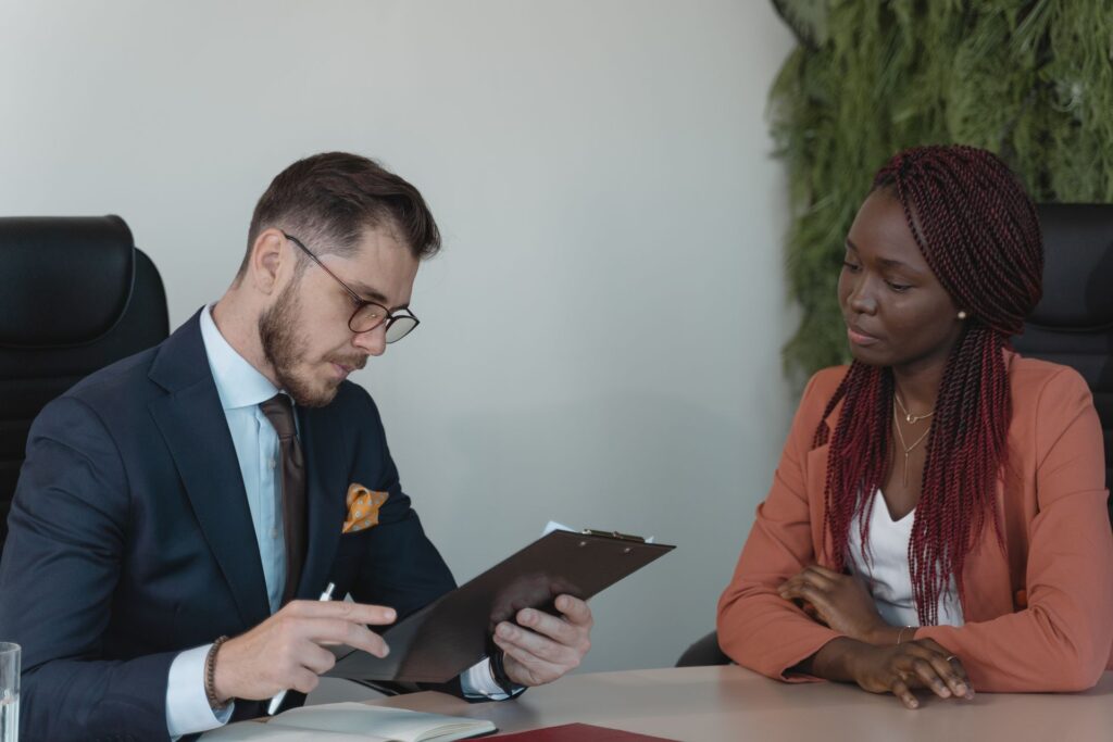 Employer reviewing a candidate's experience on a CV during a job interview