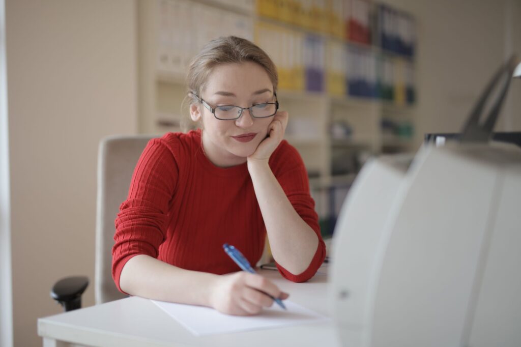 A student sorting her paperwork at a desk before completing the 2026/27 Student Finance application