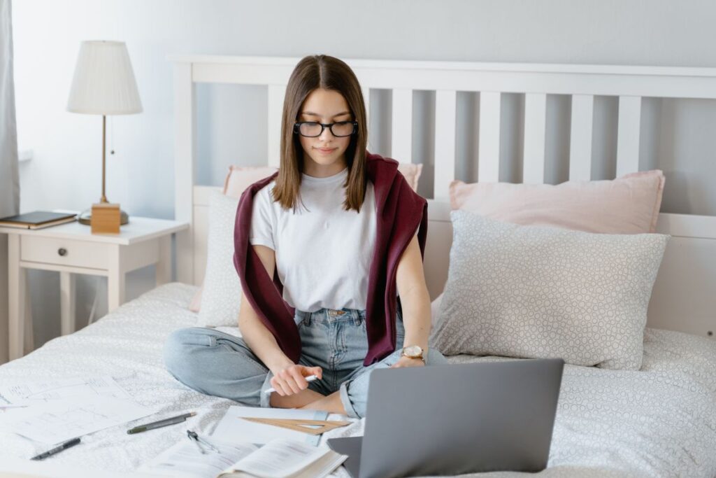 A student checking university options on a laptop during Clearing