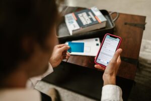 Person making an online payment using a smartphone and credit card ind