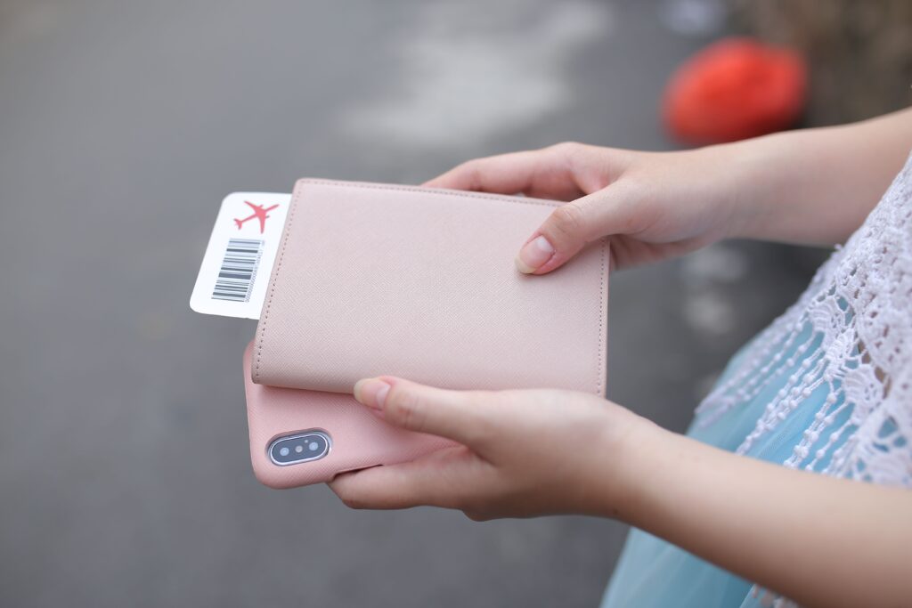 Gap year traveller holding a passport and boarding pass