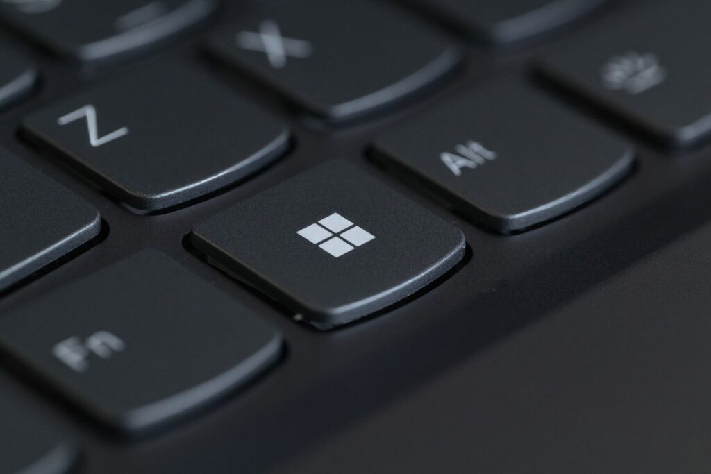 Close-up of a black laptop keyboard with the Windows key in focus