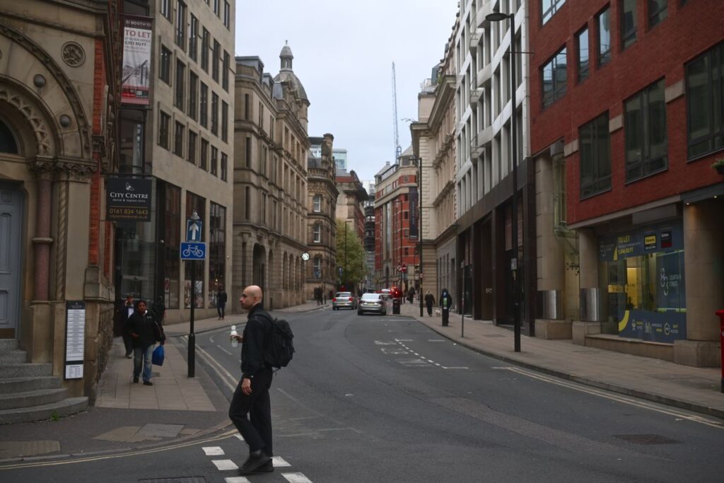 Crossing the street in Manchester city centre