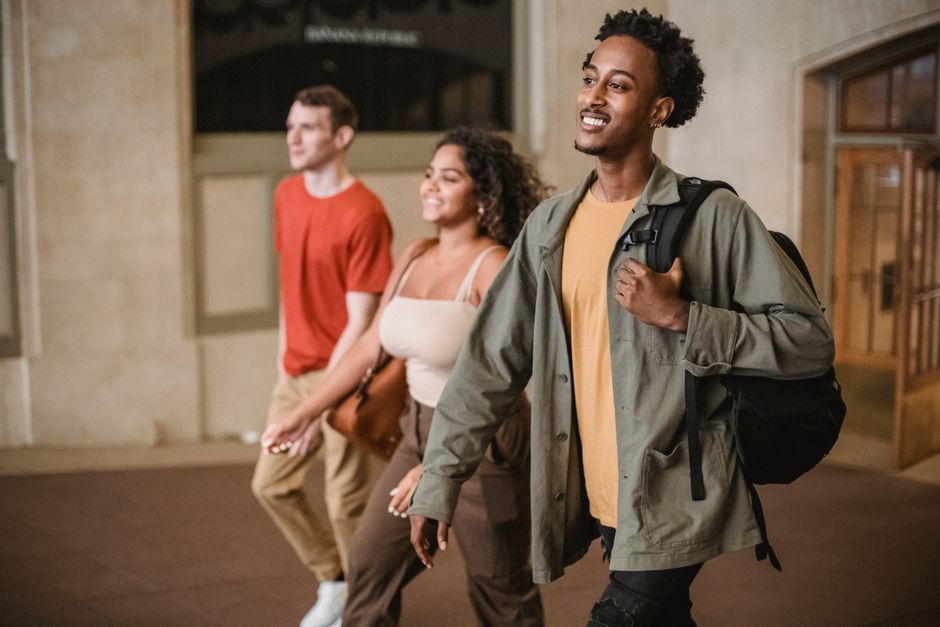 Three students walking together through a university building during freshers week