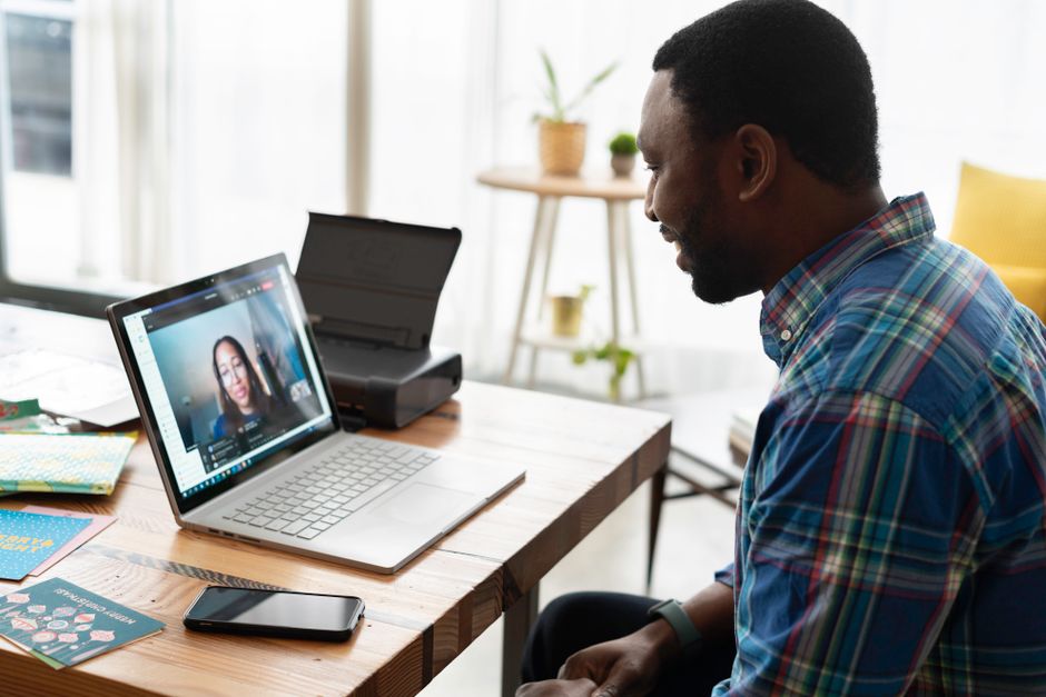 A graduate scheme candidate recording a one-way video interview to a laptop webcam
