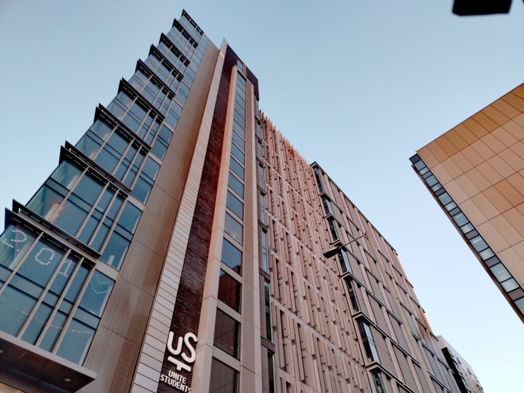 A Unite Students private halls tower, the kind that bills rent before your student loan lands
